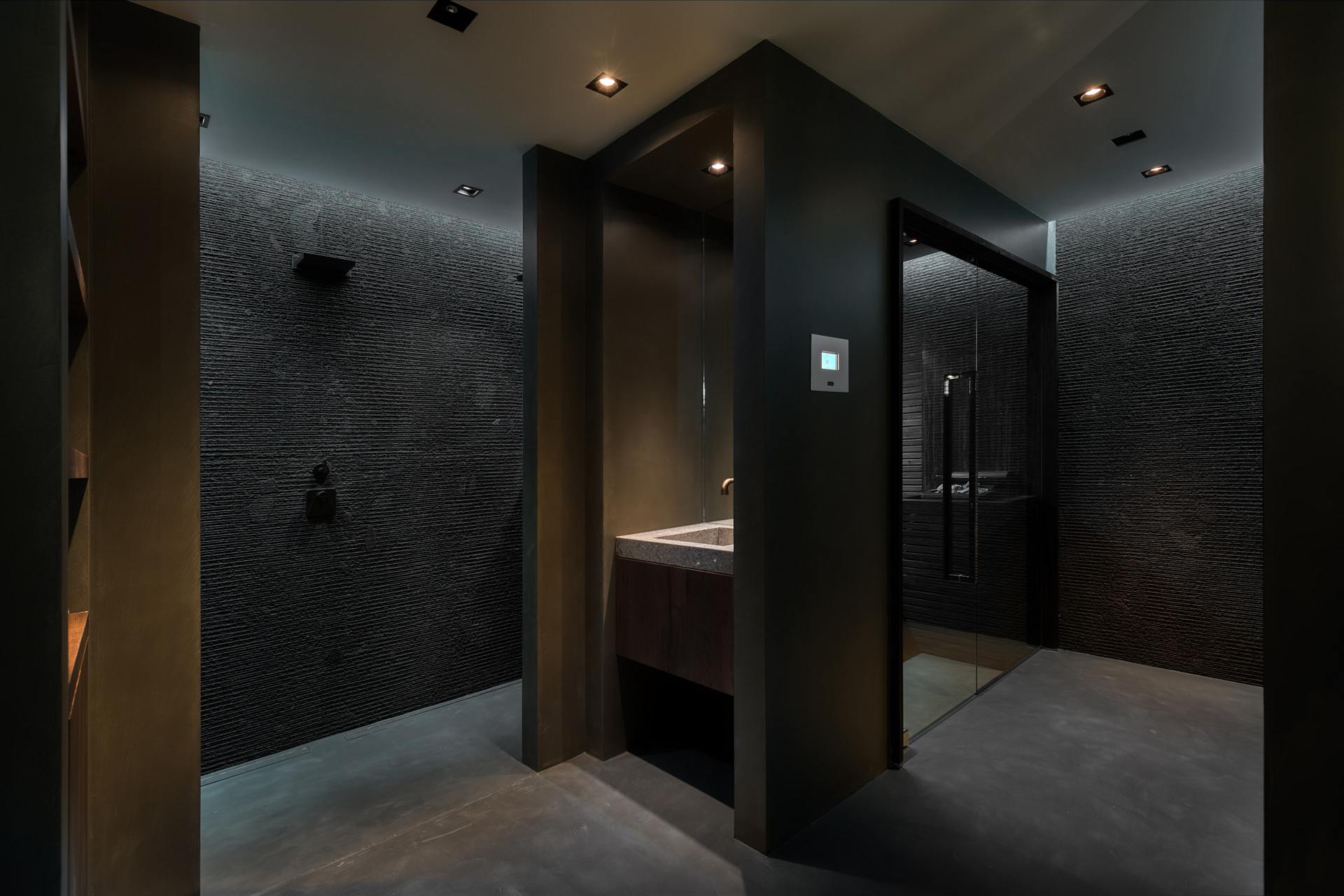 black mosaic and floor heated natural stone shower room with sauna.