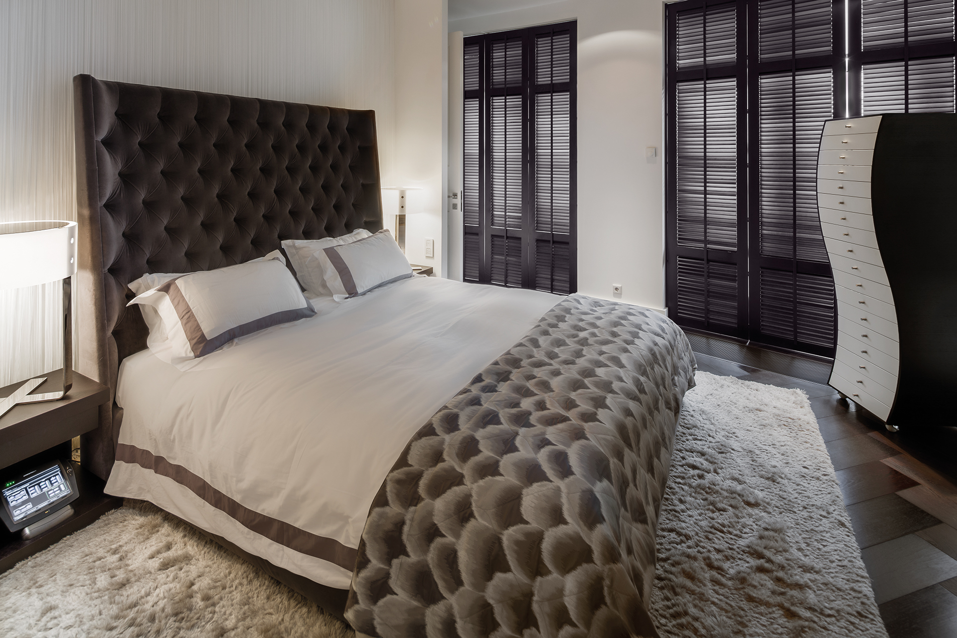 Master bedroom with a wavy cabinet and large headboard bed