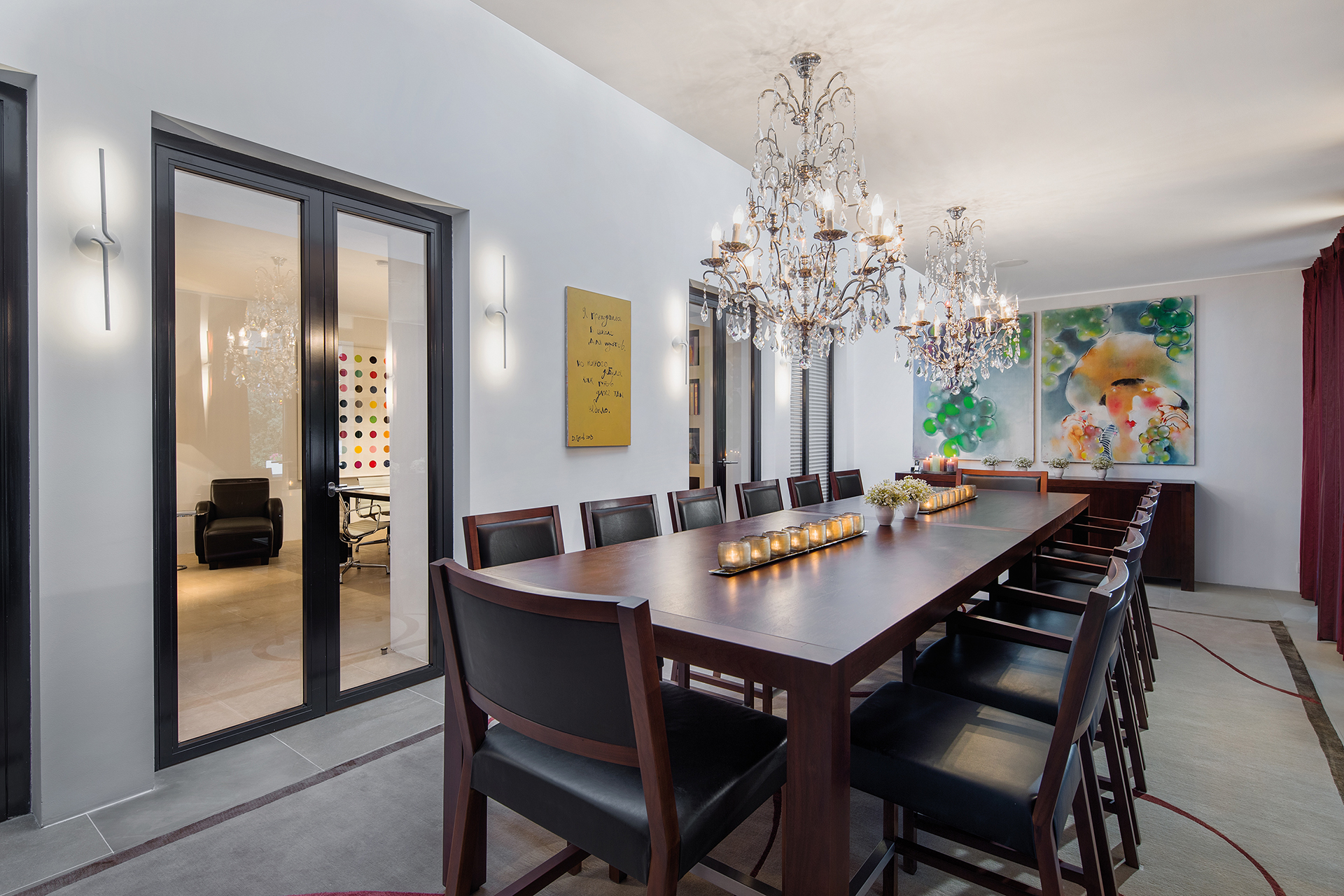 Indoor dining area with white walls and chandeliers